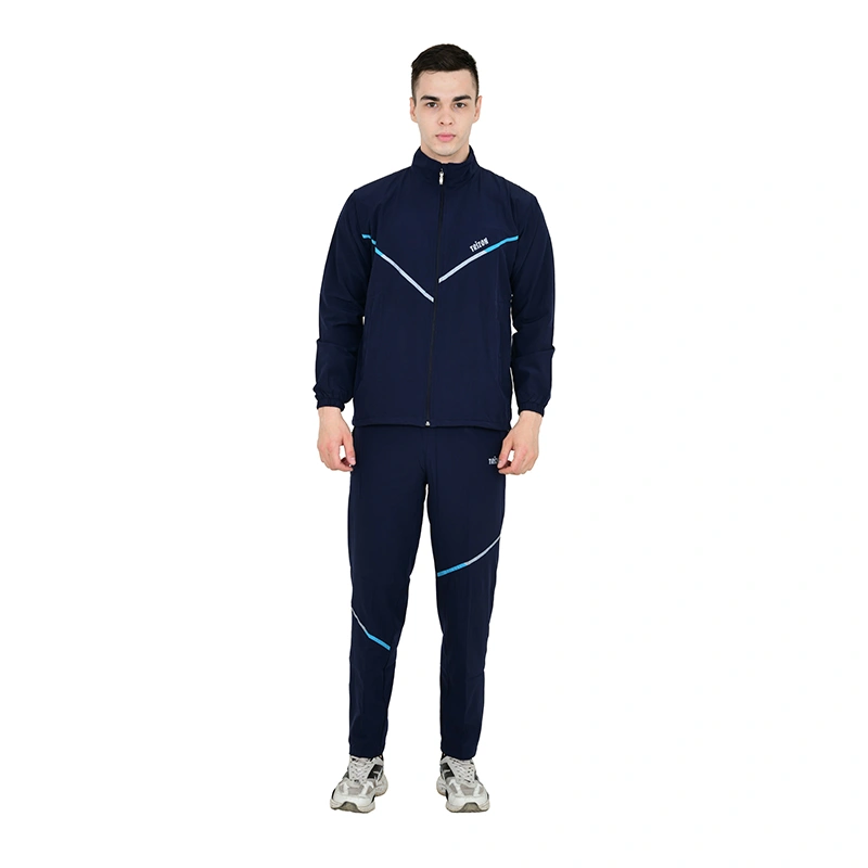 Male model in navy blue tracksuit with light blue stripe accent and grey sneakers - menswear ecommerce photography by Lohar Studio Delhi